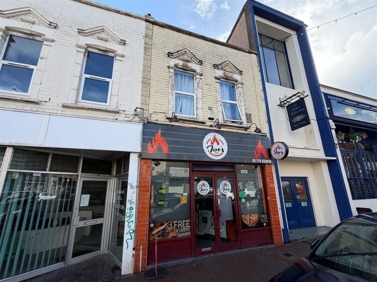 A mid terrace takeaway, of approximately 600 ft², with commercial extraction and additional first floor ancillary storage (of approx. 350 ft² Photo 1