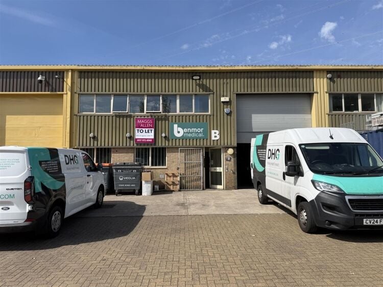 A modern unit of approximately 4,865 ft² arranged as a ground floor warehouse with roller shutter access, with additional first floor offices and Photo 1