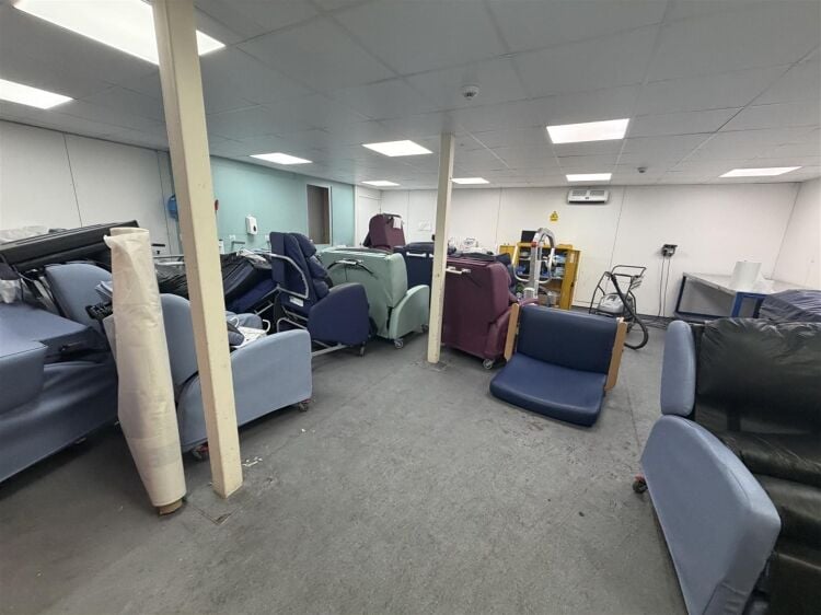A modern unit of approximately 4,865 ft² arranged as a ground floor warehouse with roller shutter access, with additional first floor offices and Photo 10