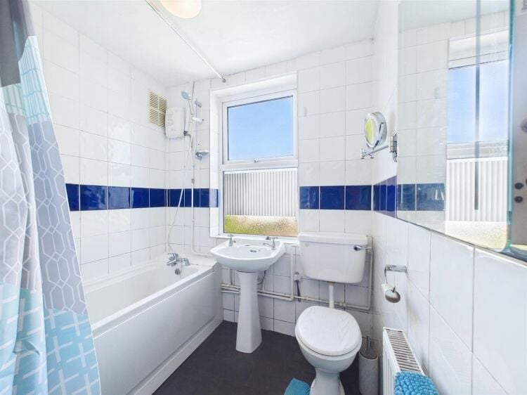 A large mixed-use investment property arranged as a ground floor shop (of approx. 740 ft²) with a large and self contained 2 bedroom flat above a Photo 11