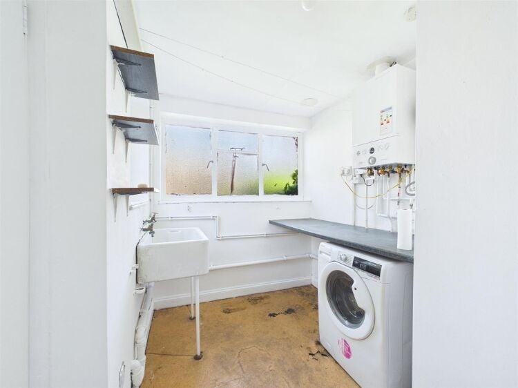 A large mixed-use investment property arranged as a ground floor shop (of approx. 740 ft²) with a large and self contained 2 bedroom flat above a Photo 12