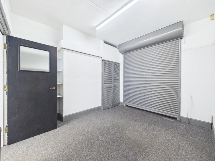 A large mixed-use investment property arranged as a ground floor shop (of approx. 740 ft²) with a large and self contained 2 bedroom flat above a Photo 14