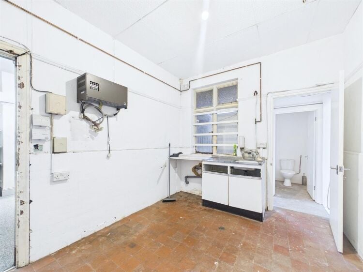 A large mixed-use investment property arranged as a ground floor shop (of approx. 740 ft²) with a large and self contained 2 bedroom flat above a Photo 15