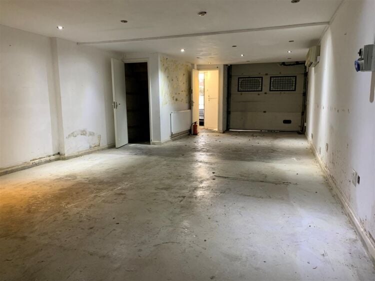 An end of terrace two storey workshop/office of approximately 1,014 ft² (94m²) with roller shutter access and off street parking to the fron Photo 2