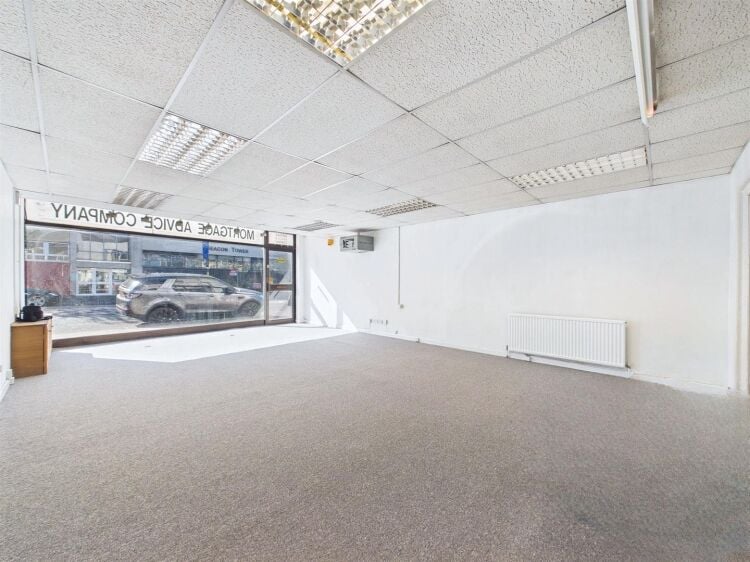 A large mixed-use investment property arranged as a ground floor shop (of approx. 740 ft²) with a large and self contained 2 bedroom flat above a Photo 2