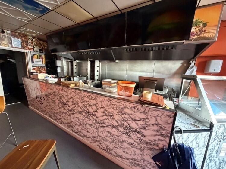 A mid terrace takeaway, of approximately 600 ft², with commercial extraction and additional first floor ancillary storage (of approx. 350 ft² Photo 2