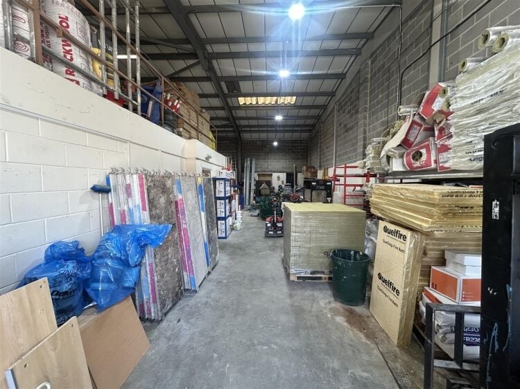A modern industrial unit of approx 2,994 ft². the ground floor is arranged as a unit with roller shutter access with reception/office, kitchen a Photo 2