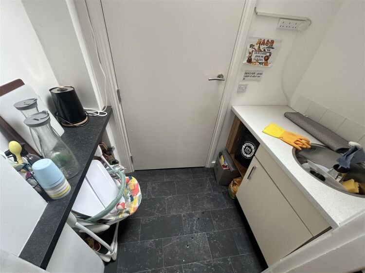A ground floor retail unit of approximately 690 ft² arranged as an open plan shop area with rear storage, kitchenette and wc. Photo 3