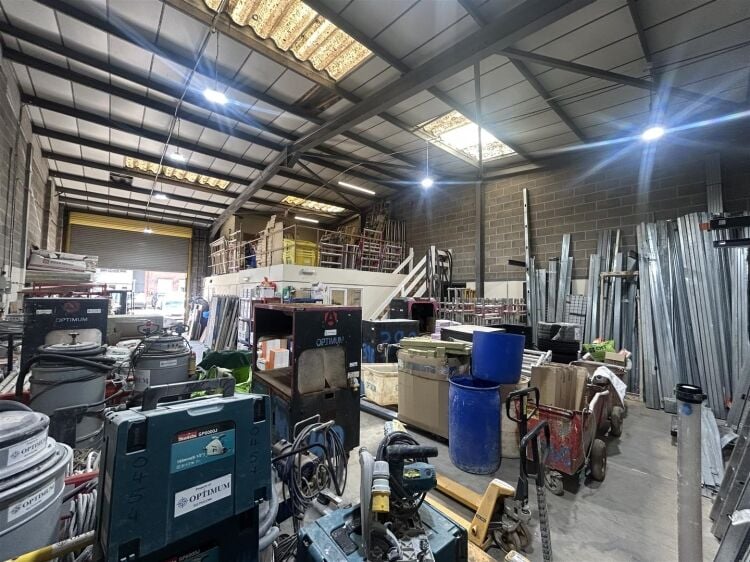 A modern industrial unit of approx 2,994 ft². the ground floor is arranged as a unit with roller shutter access with reception/office, kitchen a Photo 3