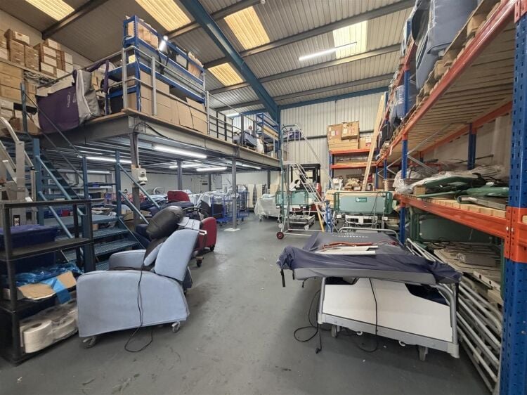 A modern unit of approximately 4,865 ft² arranged as a ground floor warehouse with roller shutter access, with additional first floor offices and Photo 3