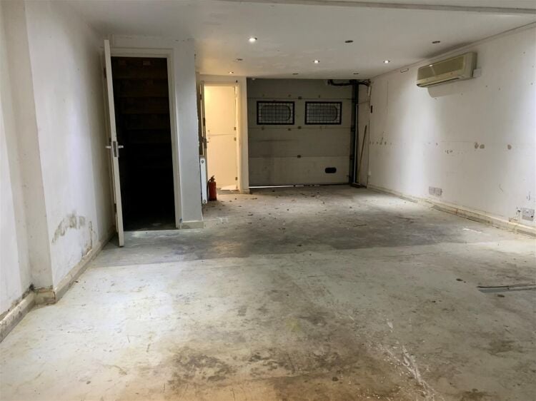 An end of terrace two storey workshop/office of approximately 1,014 ft² (94m²) with roller shutter access and off street parking to the fron Photo 4