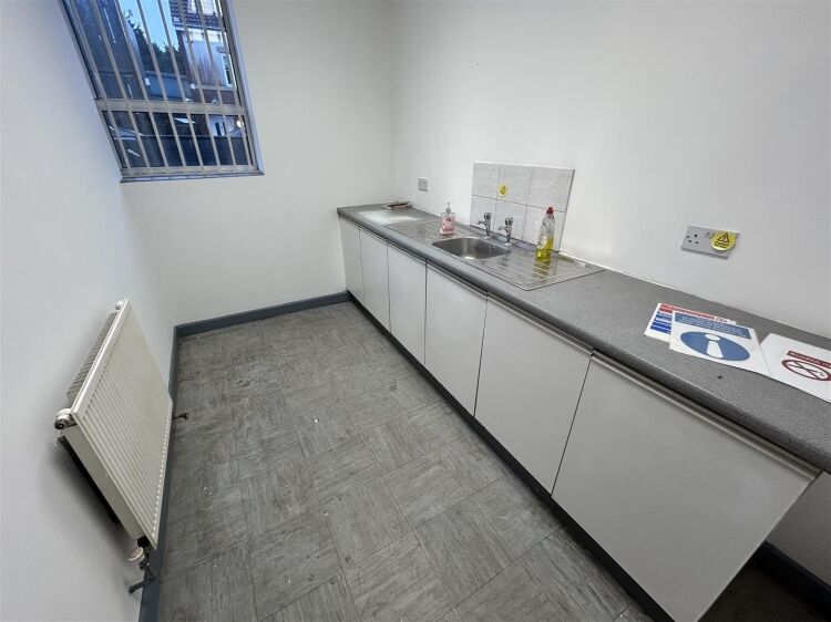 A ground floor office of approx 1,500 ft² with additional toilet facilities. the property benefits from allocated parking, security shutters, and Photo 4