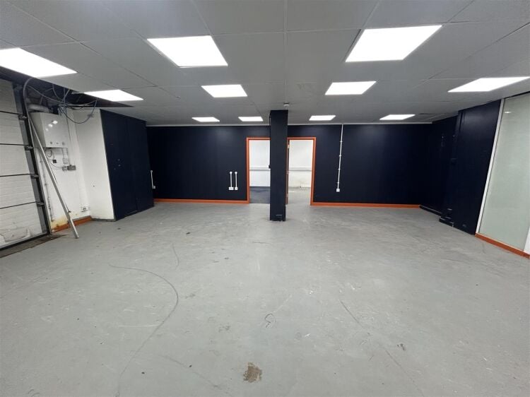 Ground floor industrial unit/workshop of approximately 1,256 sq ft arranged as open plan workspace with adjoining storage and workshop space. the unit Photo 4