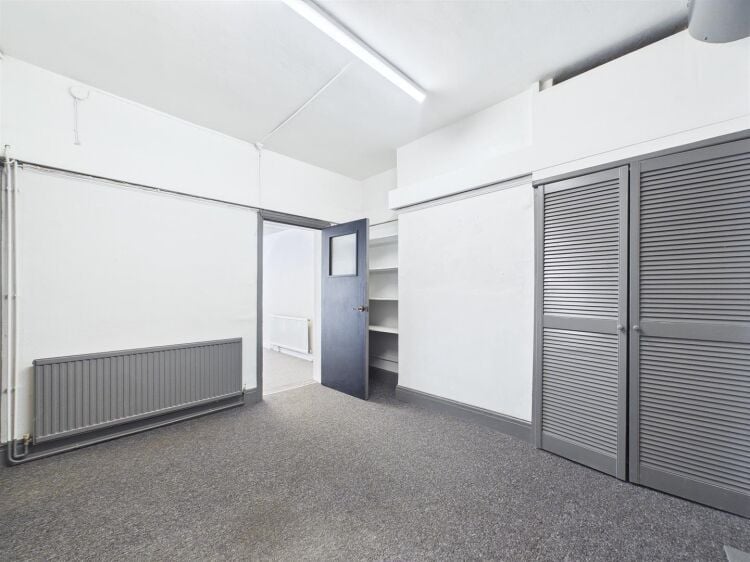 A large mixed-use investment property arranged as a ground floor shop (of approx. 740 ft²) with a large and self contained 2 bedroom flat above a Photo 4