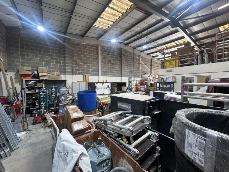A modern industrial unit of approx 2,994 ft². the ground floor is arranged as a unit with roller shutter access with reception/office, kitchen a Photo 4