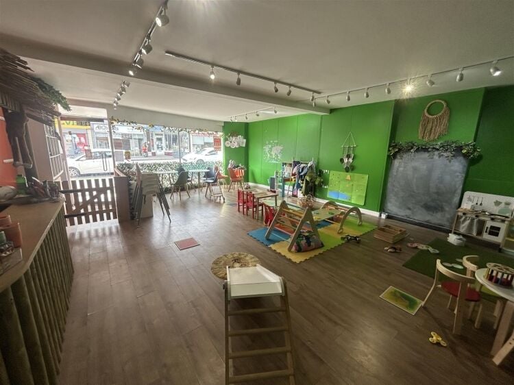 A ground floor retail unit of approximately 690 ft² arranged as an open plan shop area with rear storage, kitchenette and wc. Photo 5