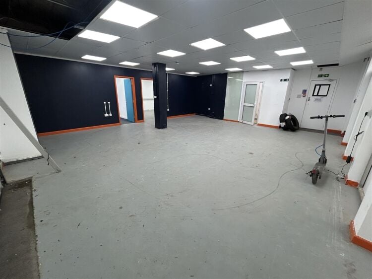 Ground floor industrial unit/workshop of approximately 1,256 sq ft arranged as open plan workspace with adjoining storage and workshop space. the unit Photo 5