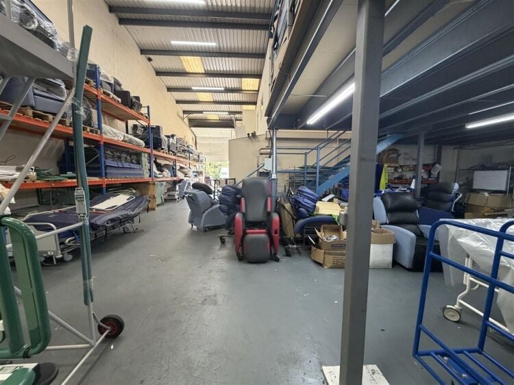 A modern unit of approximately 4,865 ft² arranged as a ground floor warehouse with roller shutter access, with additional first floor offices and Photo 6