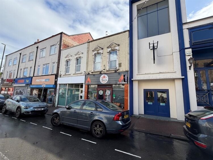 A mid terrace takeaway, of approximately 600 ft², with commercial extraction and additional first floor ancillary storage (of approx. 350 ft² Photo 7