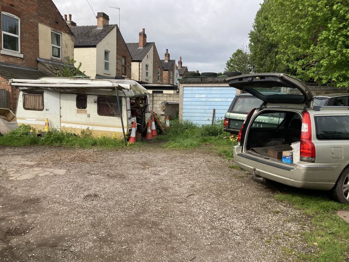 Freehold large garage and yard. Garage will take up to 5 cars and work on them. Parking for 12 cars.