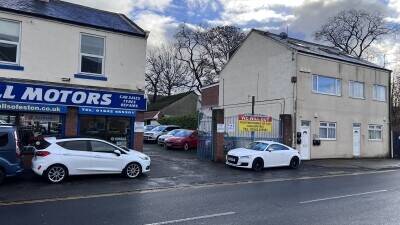 Established Car sales and repair dealership with flats.With planning permission to build on