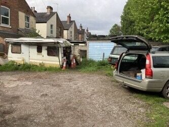 Freehold large garage and yard. Garage will take up to 5 cars and work on them. Parking for 12 cars.