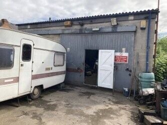 Freehold large garage and yard. Garage will take up to 5 cars and work on them. Parking for 12 cars.